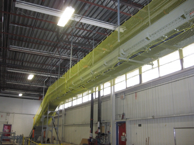 Ceiling mounted Conveyor netting in clothing distribution warehouse | Safety netting