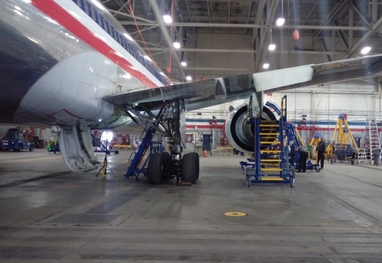 Aircraft access stands in use on various aircraft points in hangar