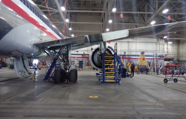 Wheel well access stand under wing of American Airlines plane