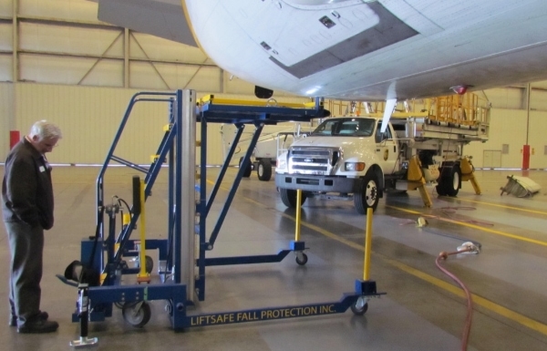 Wheel well access stand being observed in hangar