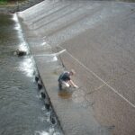 Custom long span lifeline at a hydro dam in use | custom fall protection
