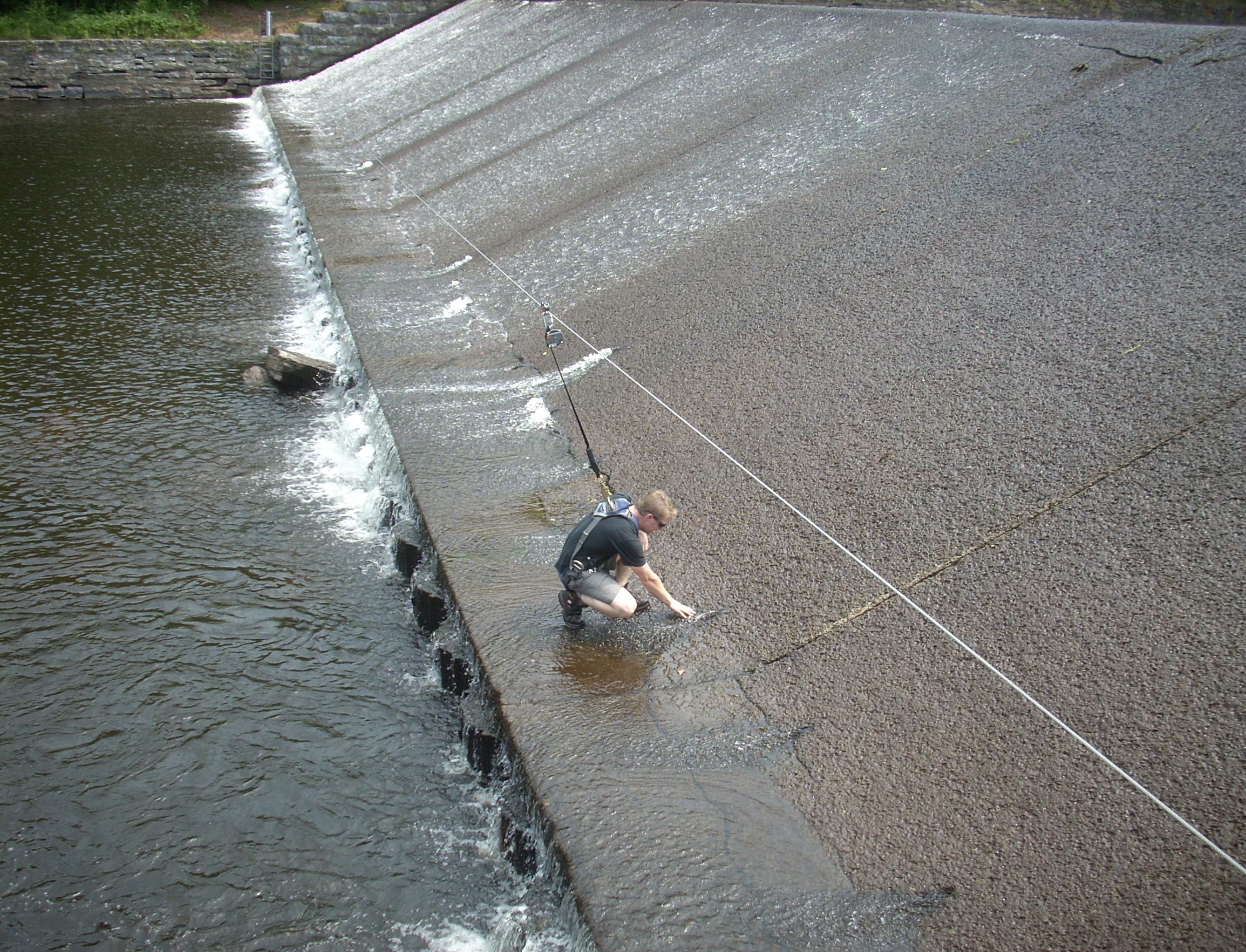 Custom long span lifeline at a hydro dam in use | custom fall protection