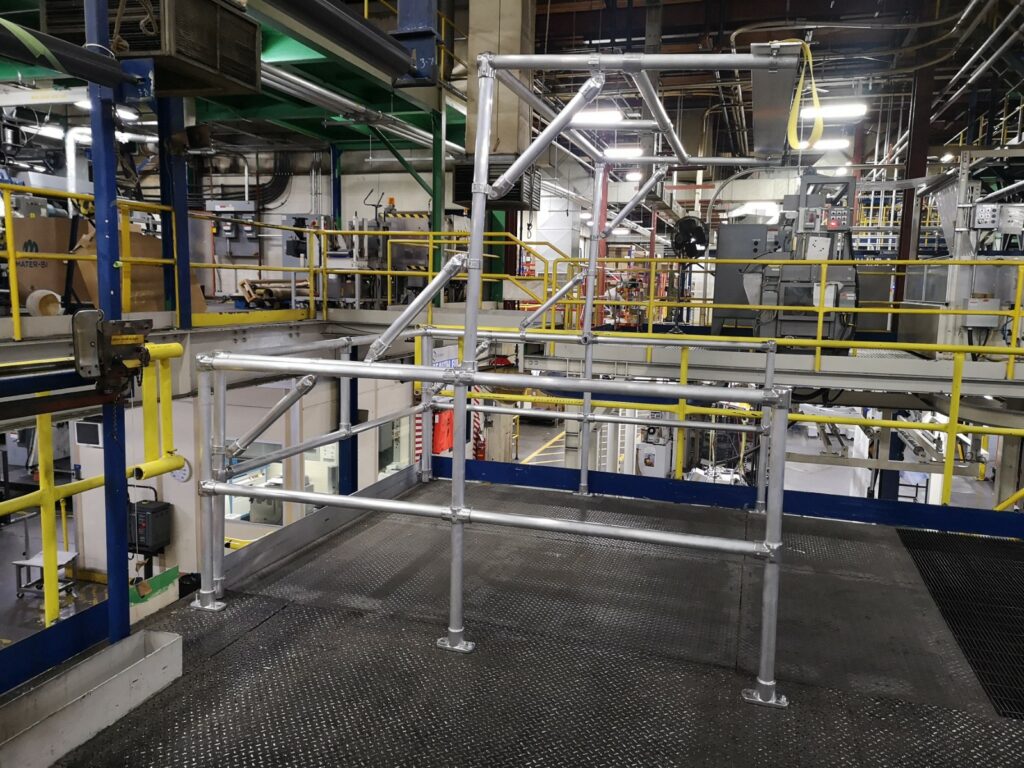 Pivoting guardrail gate system for loading a mezzanine